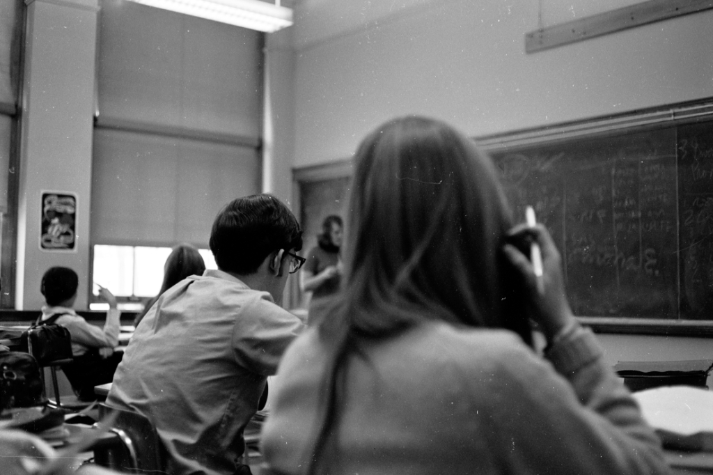 Teacher in background with students in foreground