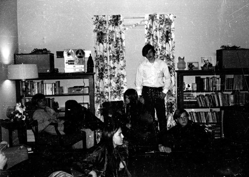 group listening to music on reel to reel player.