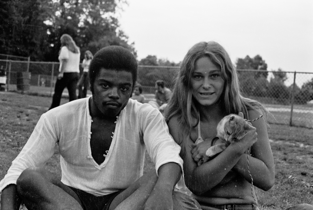 Couple at Brookdale Park holding cat on a string.