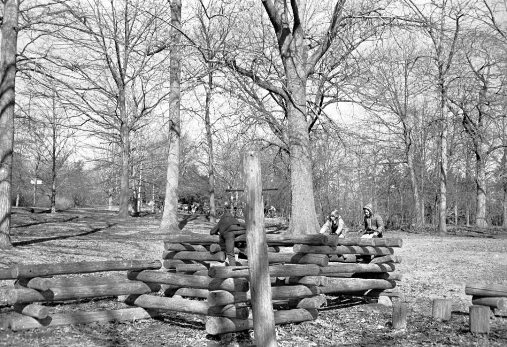 Brookdale Park log climbing play equipment with children.