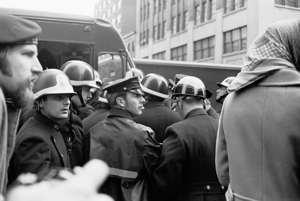 Crowd Control near Police van to facilitate arrests